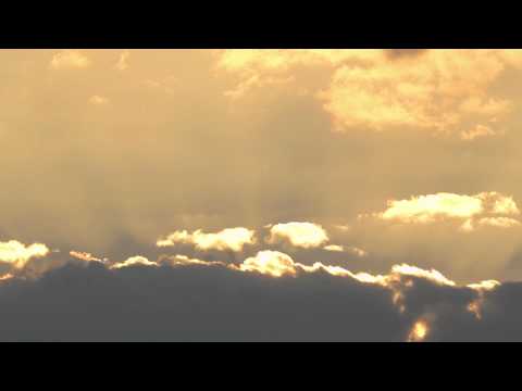 Morning sunrise time lapse with red sky and moving clouds with sunbeams
